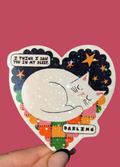 A heart shaped sticker featuring a sleeping white cat with a patchwork night sky background and text bubbles reading 'I THINK I SAW YOU IN MY SLEEP' and 'DARLING', held by a hand against a solid pink background.